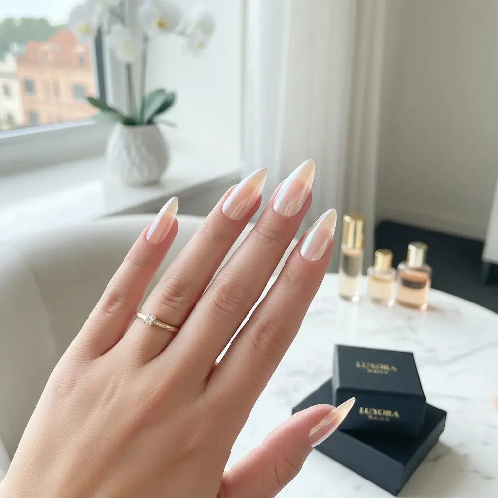 Press to Impress Rose Glaze soft blush pink stiletto nails with luminous pearl chrome finish.