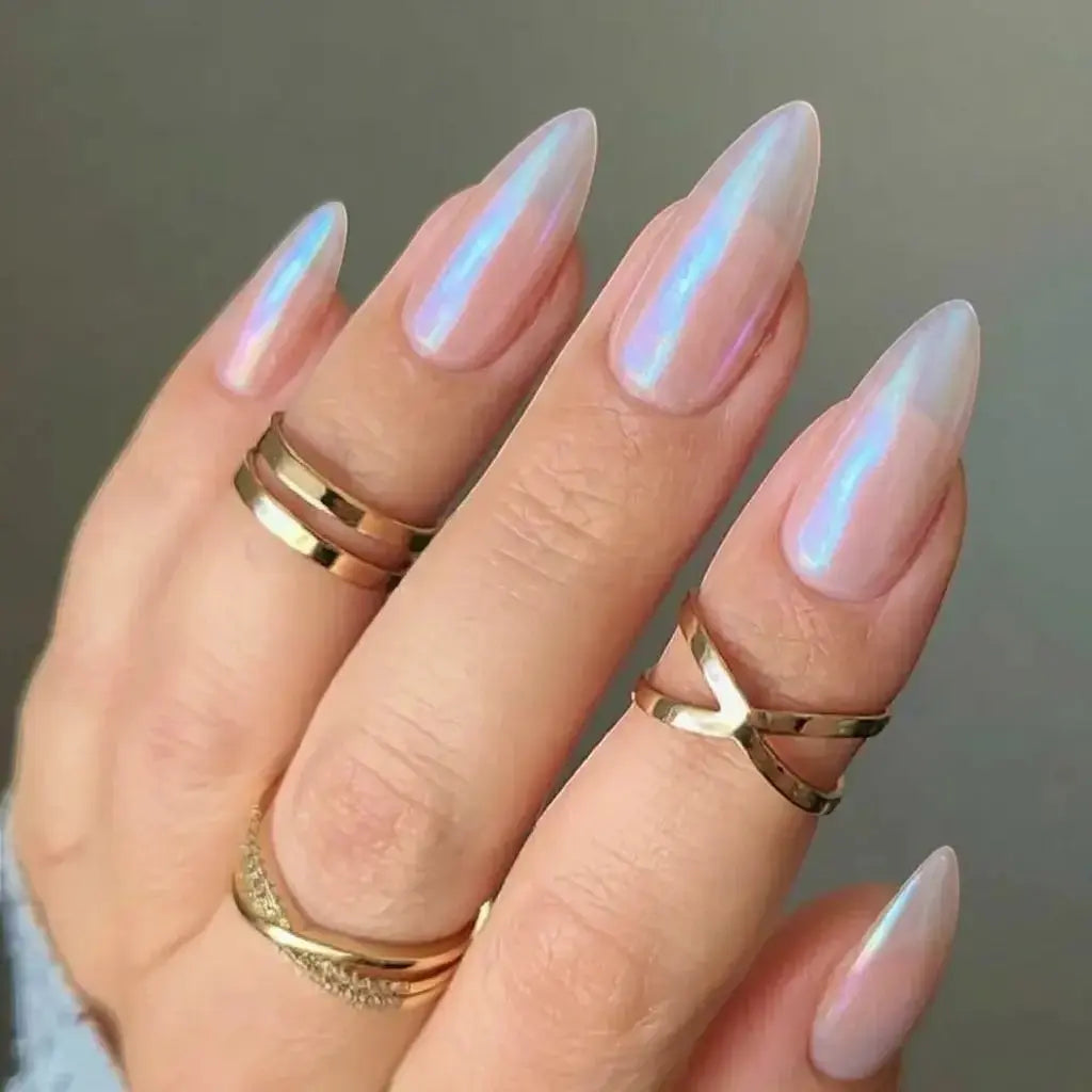 Press to Impress Rose Glaze stiletto nails with pearlescent pink and blue chrome finish. Stacked gold rings.