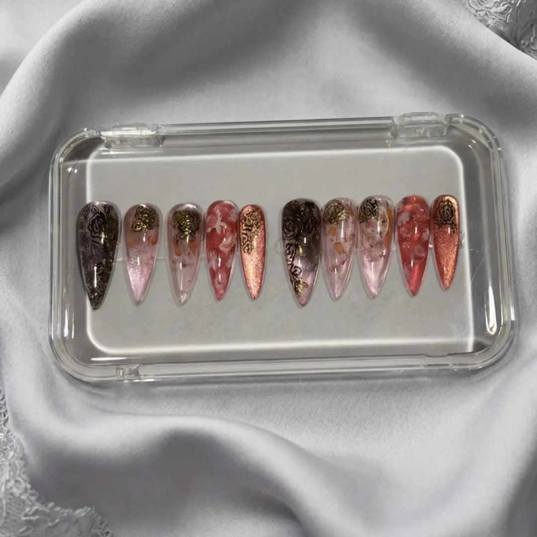Press to Impress Rose of Shadows luxury press on nails in burgundy, pink, and rose gold with gold floral accents.