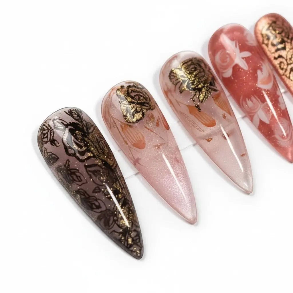 Press to Impress Rose of Shadows luxury press on nails in burgundy, rose gold, and sheer pink with gold floral accents.