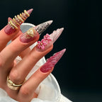 Press to Impress Rouge Sculpt stiletto press-on nails with pink glitter, 3D flowers, gold heart charm, and gold rings.