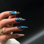 Press to Impress Saphire Relic stiletto press-on nails in blue, gold, and nude with rhinestones and 3D embellishments.