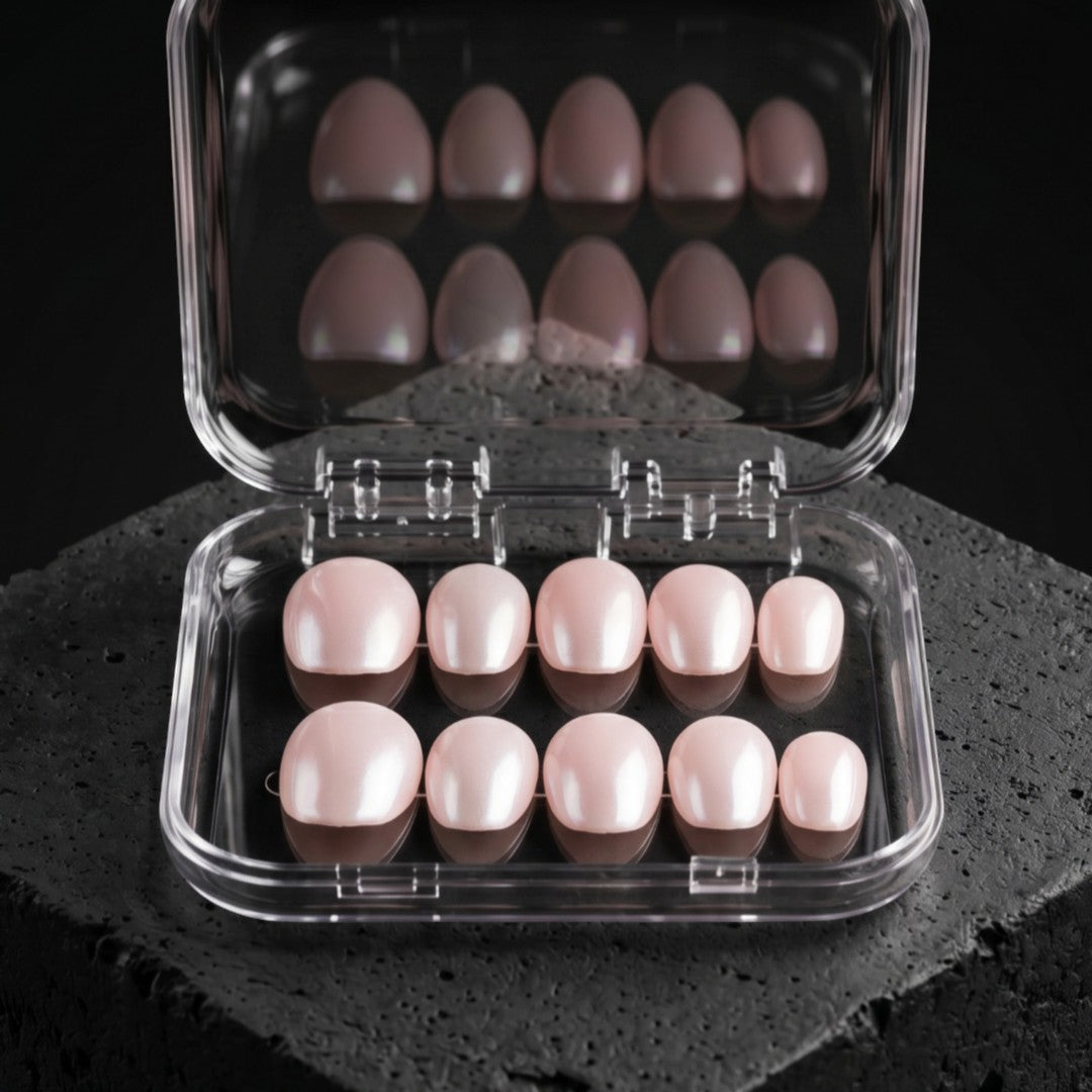 Press to Impress Soft Petal Nude short round press-on nails in a clear case. Delicate soft pink nude hue.