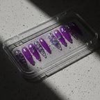Press to Impress Violet Mirage stiletto press on nails with holographic glitter and butterfly accents.