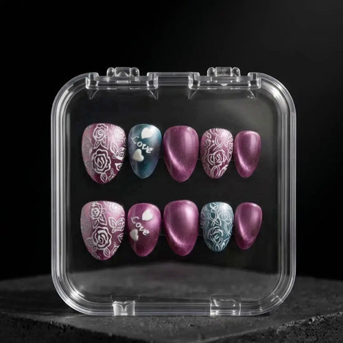 Press to Impress Amour Bloom extra-short almond press-on nails with rose, love, and ombré designs in mauve, plum, teal, and white.
