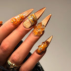 Close-up of Pumpkin Hour nails with amber sculptural flower, pumpkins and copper shimmer